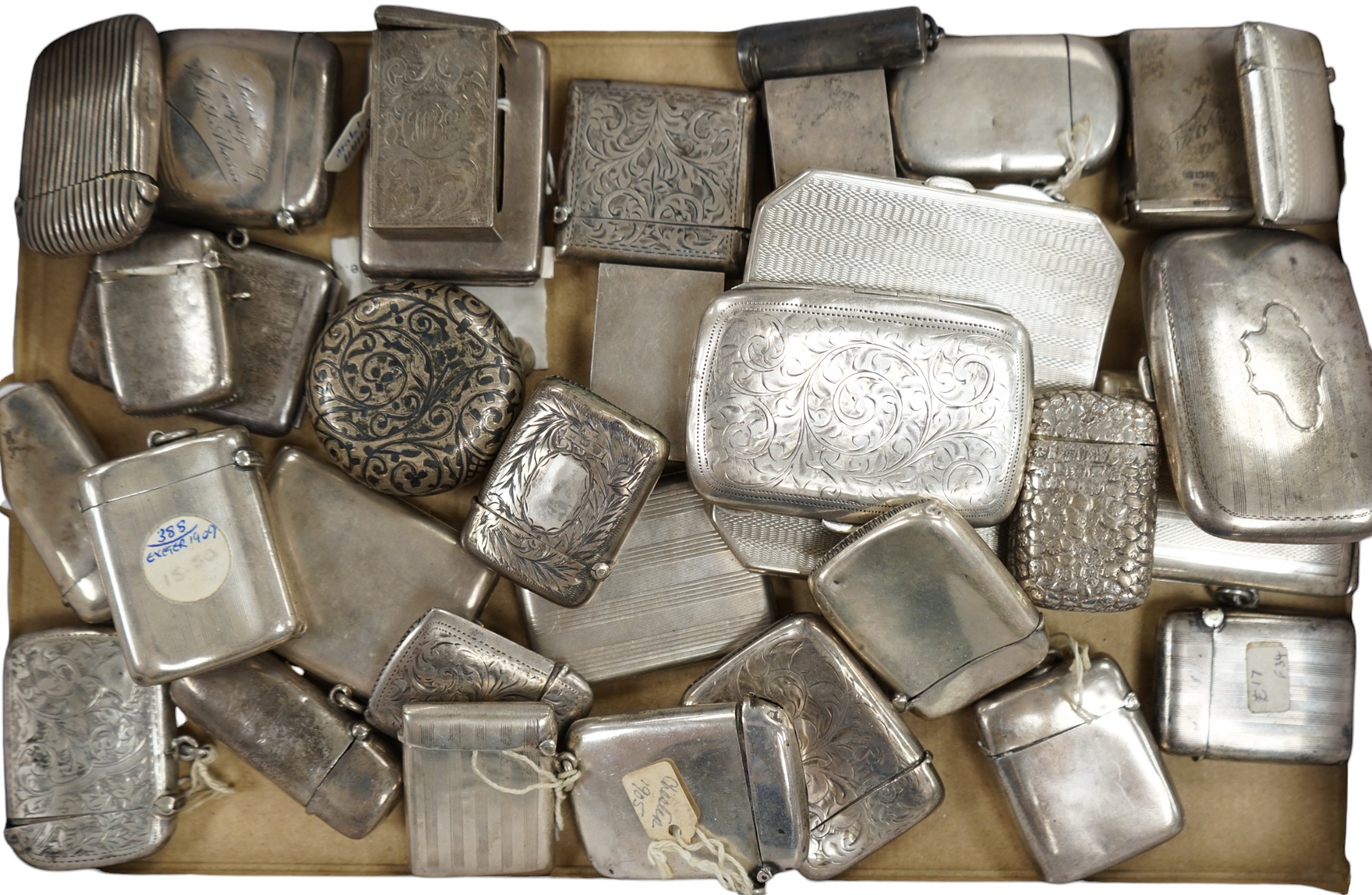 A collection of twenty four assorted silver vesta cases, eight cigarette cases, two match sleeves and a late 19th century Russian 84 zolotnik niello small tobacco box. Condition - poor to fair